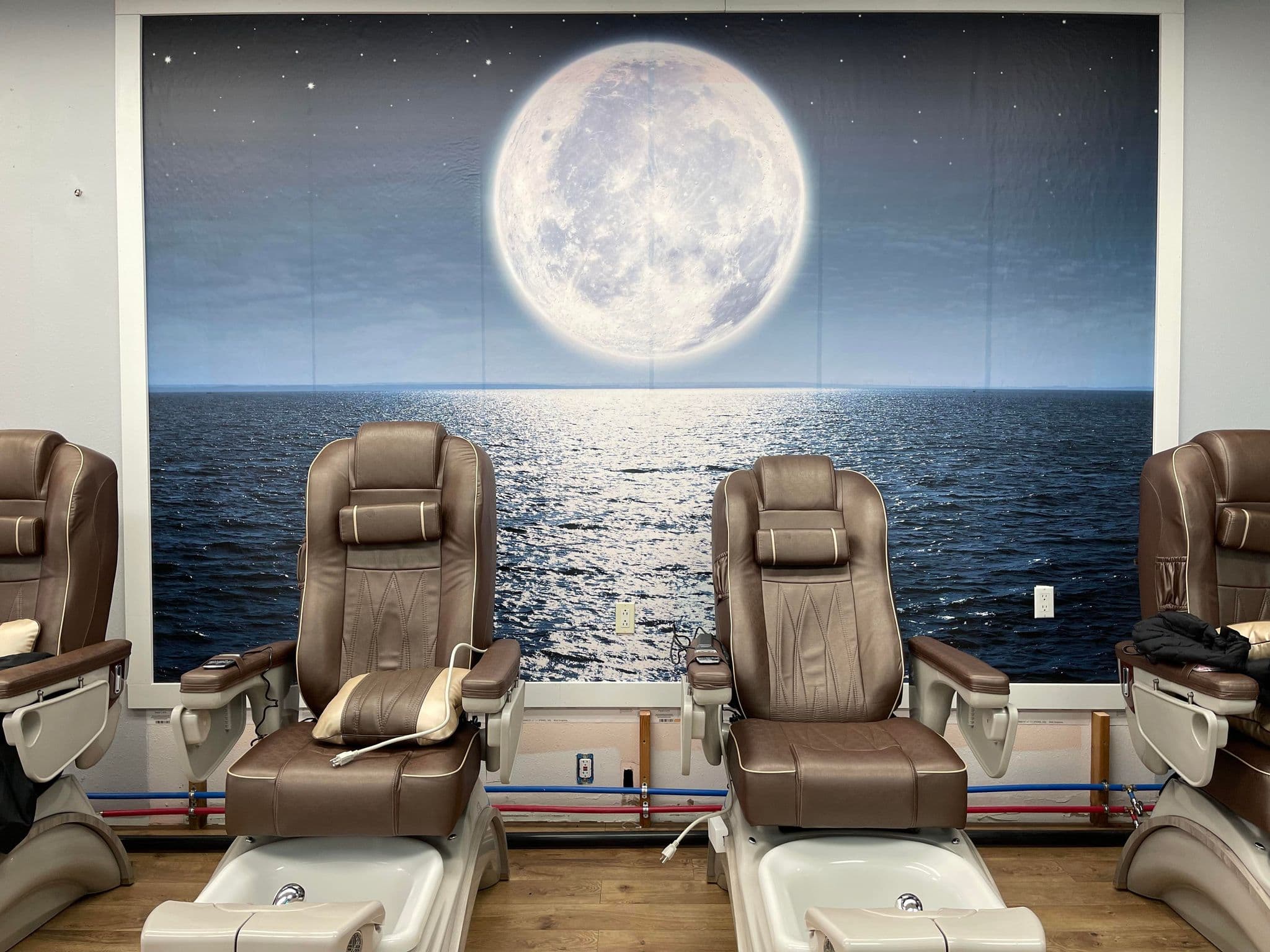 The new moon mural above the pedicure chairs at New Moon Nails and Spa